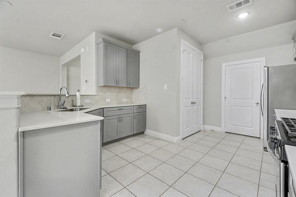 520 Teton Street Allen, TX 75002 - Photo 8 of 26 a kitchen with stainless steel appliances a sink and a refrigerator