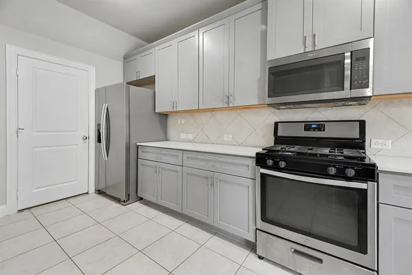 a kitchen with granite countertop cabinets and steel stainless steel appliances