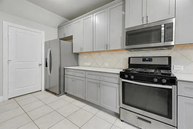 a kitchen with granite countertop cabinets and steel stainless steel appliances