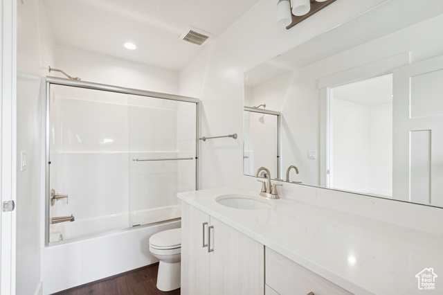 1615 North Angel Street, Unit I Layton, UT 84041 - Photo 28 of 56 Bathroom featuring enclosed tub / shower combo, vanity, dark wood finished floors, and recessed lighting