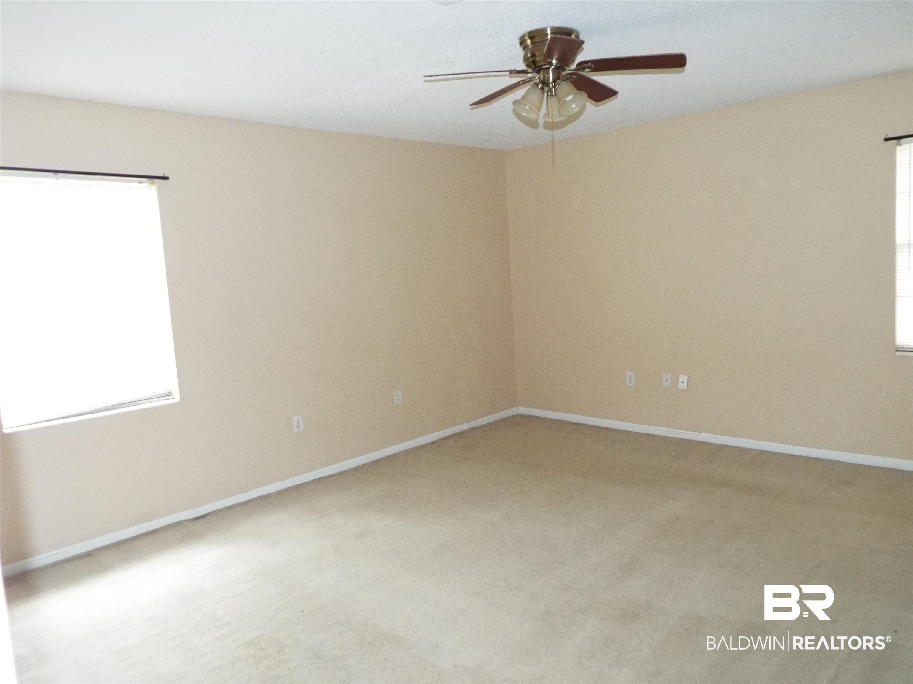 604 Southern Way Spanish Fort, AL 36527 - Photo 10 of 13 Spare room with carpet, ceiling fan, and a wealth of natural light
