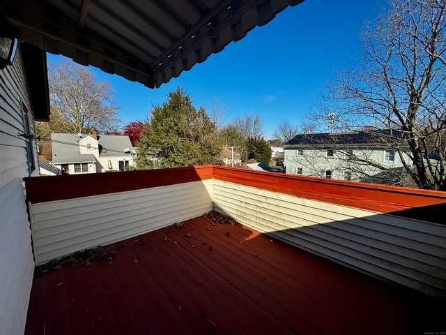 a view of a roof deck with wooden floor and fence