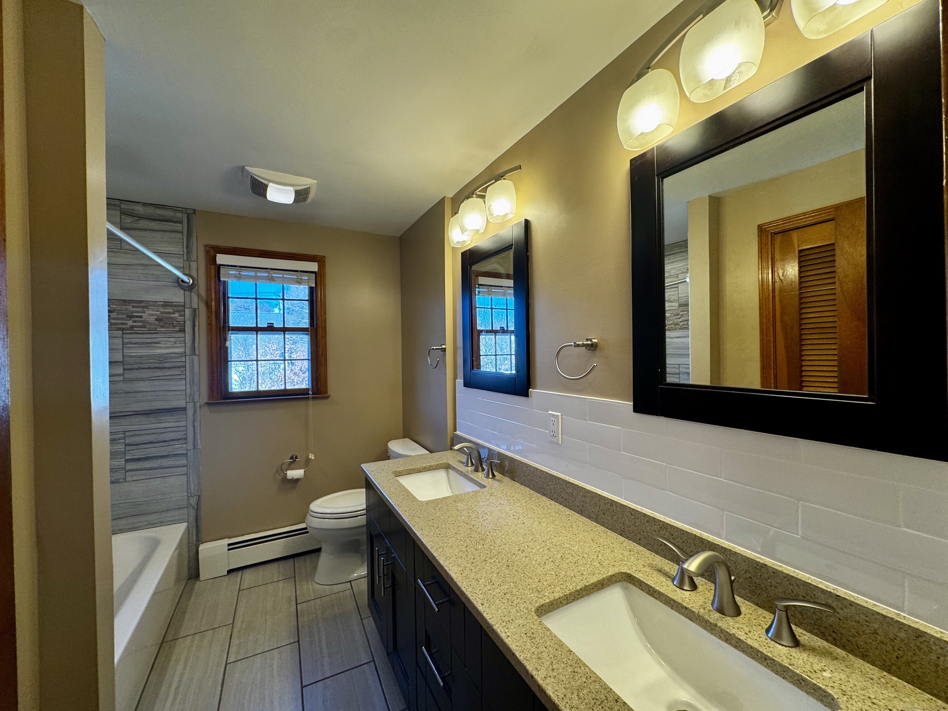 432 Wiklund Avenue Stratford, CT 06614 - Photo 14 of 19 a bathroom with a sink a mirror and a bathtub