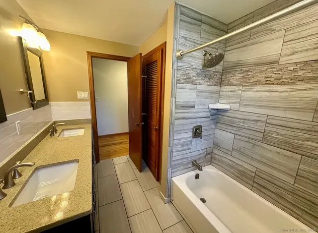 a bathroom with a bathtub and a shower