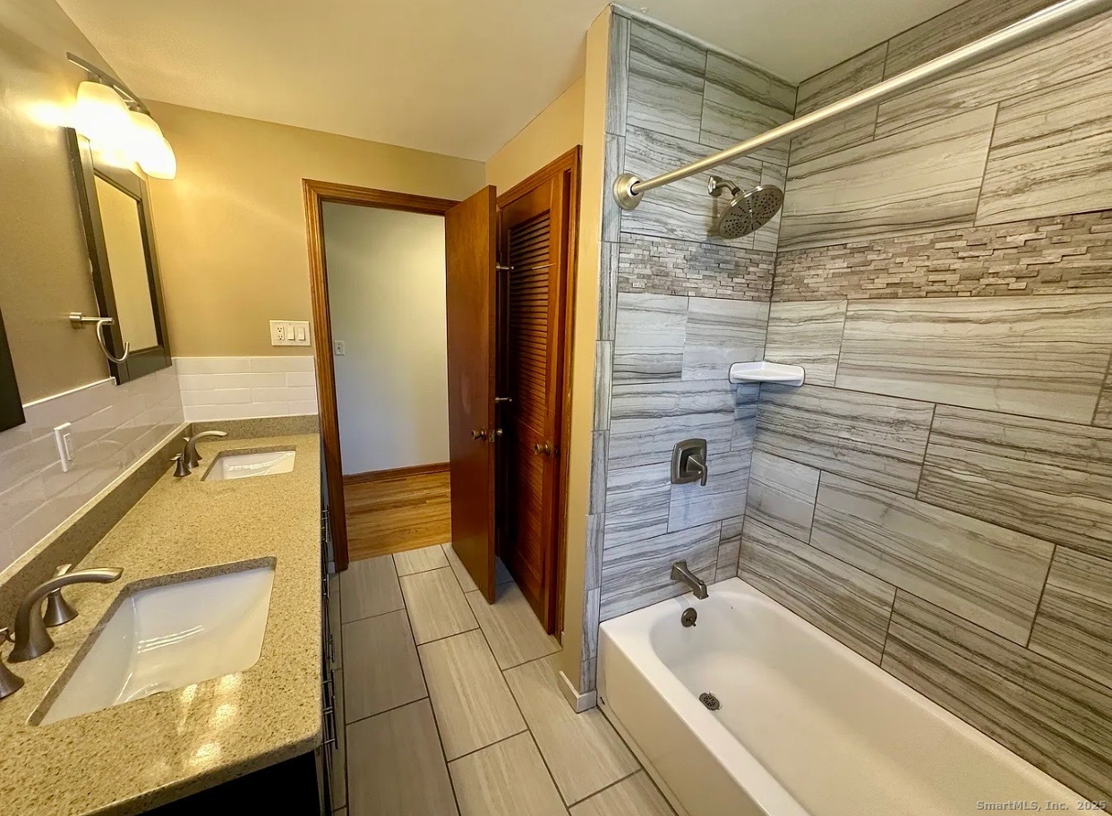 432 Wiklund Avenue Stratford, CT 06614 - Photo 15 of 19 a bathroom with a bathtub and a shower