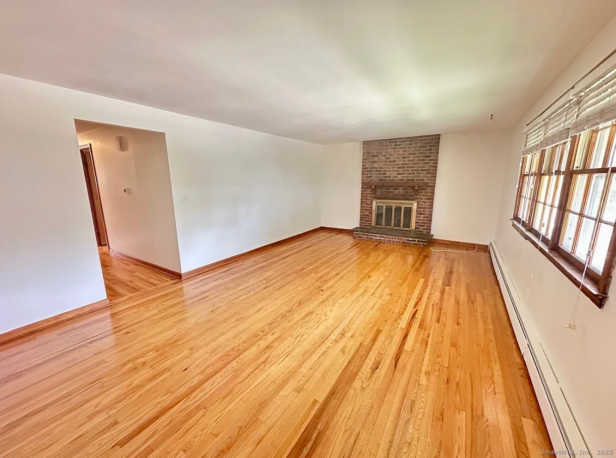 432 Wiklund Avenue Stratford, CT 06614 - Photo 7 of 19 wooden floor in an empty room with a window