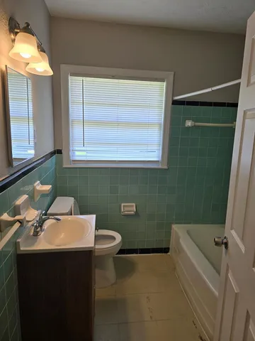 a bathroom with a sink toilet and tub