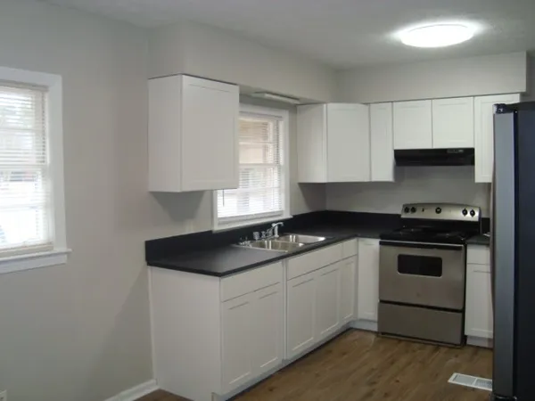 a kitchen with a sink stove and cabinets