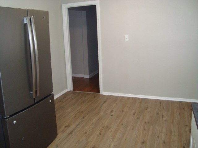 804 Goodson Drive Columbus, GA 31907 - Photo 6 of 21 an empty room with wooden floor and a window