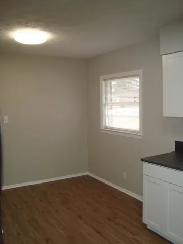 a room with a window and wooden floor