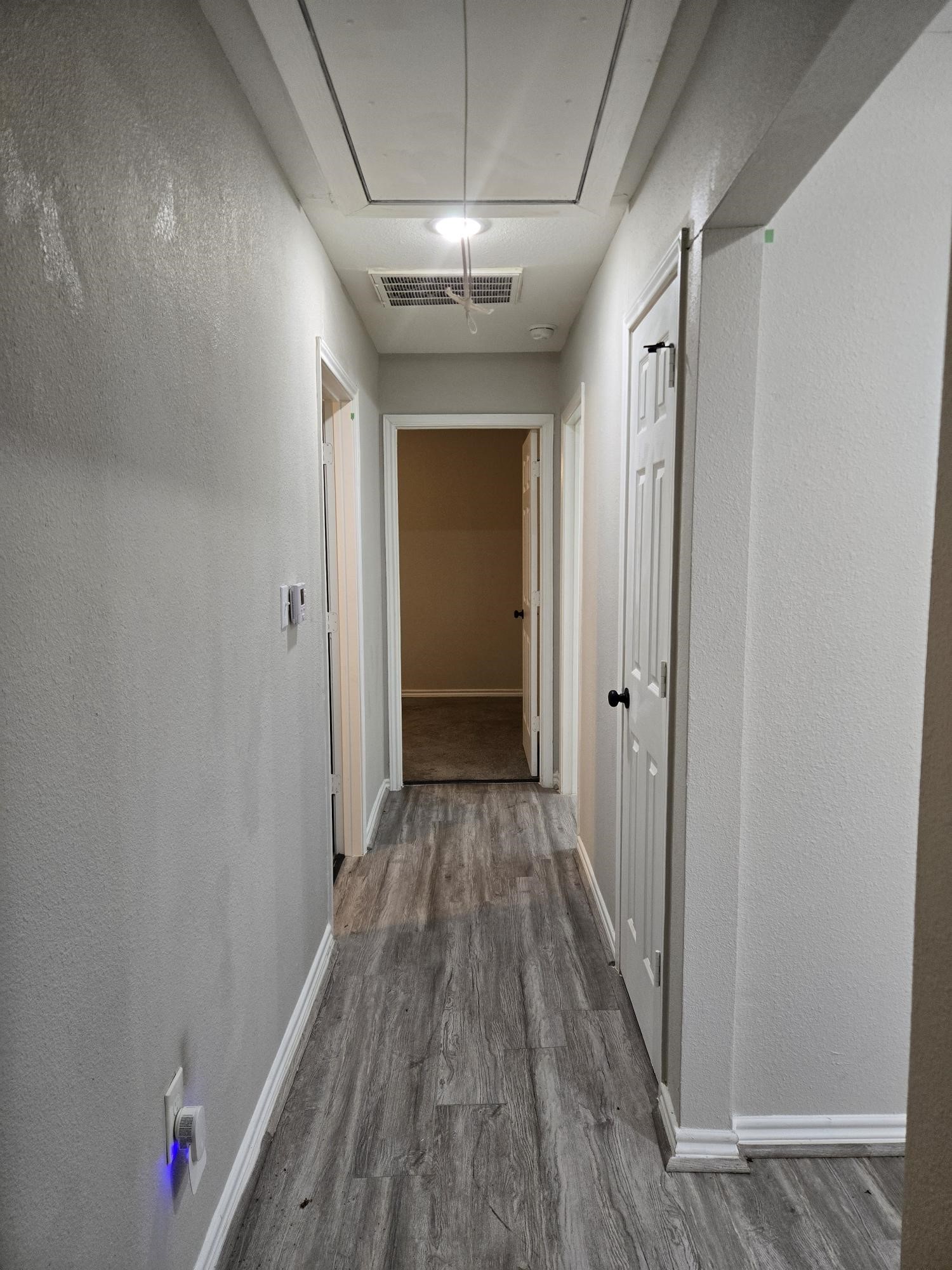 3102 Friar Point Road Houston, TX 77051 - Photo 6 of 11 Bright hallway with laminate flooring and ample lighting.