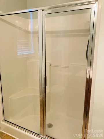 a bathroom with a glass shower door