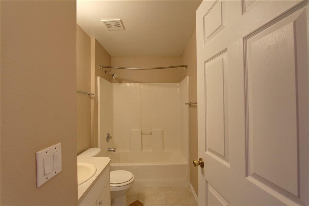 2477 Deercroft Drive Melbourne, FL 32940 - Photo 12 of 30 a bathroom with a toilet and shower