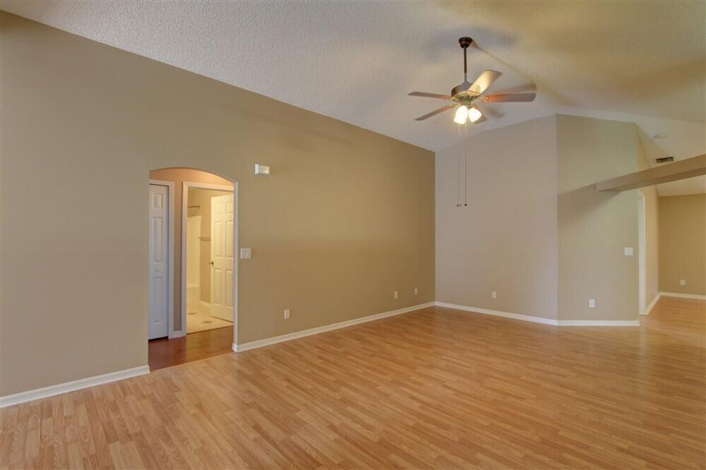 2477 Deercroft Drive Melbourne, FL 32940 - Photo 15 of 30 wooden floor in an empty room with a window