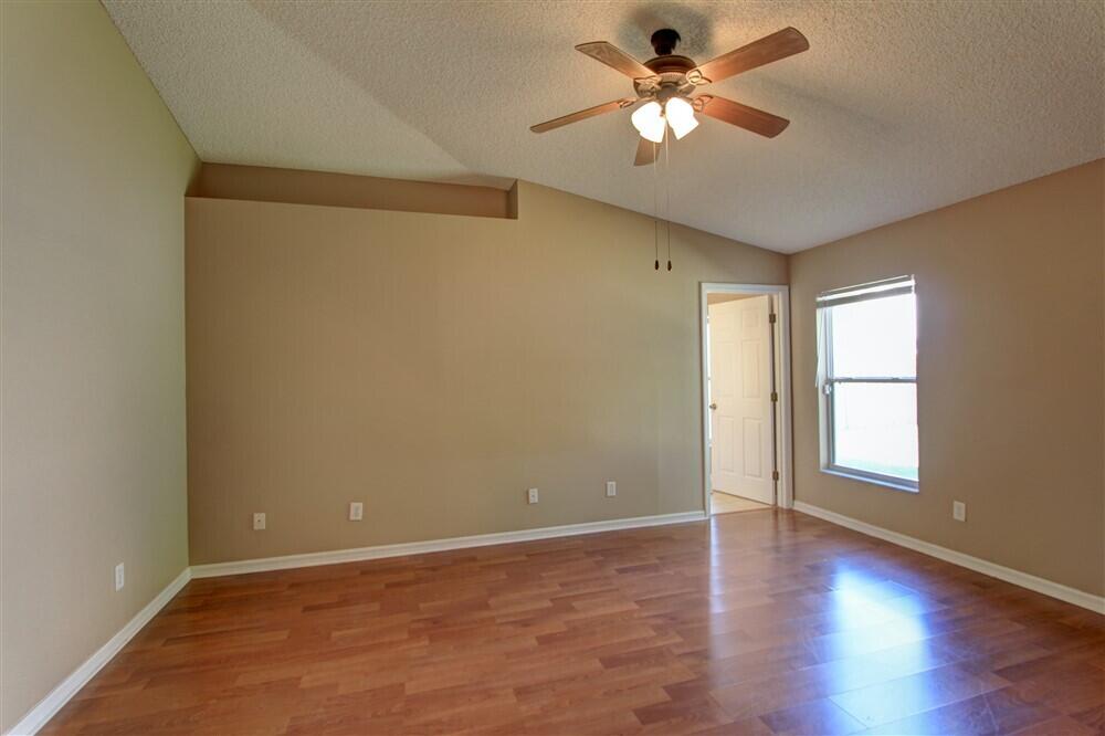 2477 Deercroft Drive Melbourne, FL 32940 - Photo 16 of 30 wooden floor in an empty room with a window