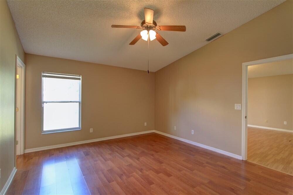 2477 Deercroft Drive Melbourne, FL 32940 - Photo 17 of 30 wooden floor in an empty room with a window