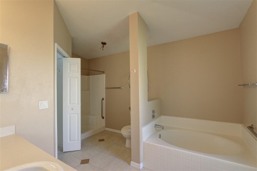 2477 Deercroft Drive Melbourne, FL 32940 - Photo 18 of 30 a bathroom with a bathtub and a toilet
