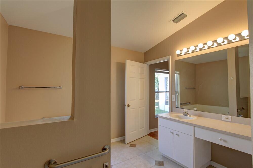 2477 Deercroft Drive Melbourne, FL 32940 - Photo 19 of 30 a bathroom with a double vanity sink and a mirror