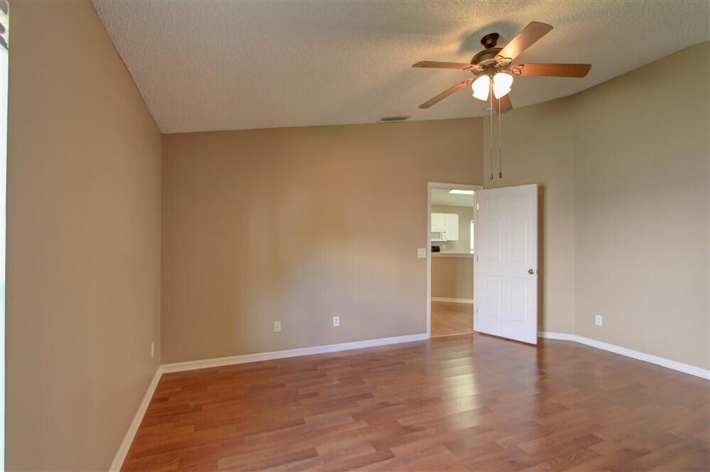 2477 Deercroft Drive Melbourne, FL 32940 - Photo 20 of 30 a view of an empty room with a chandelier fan