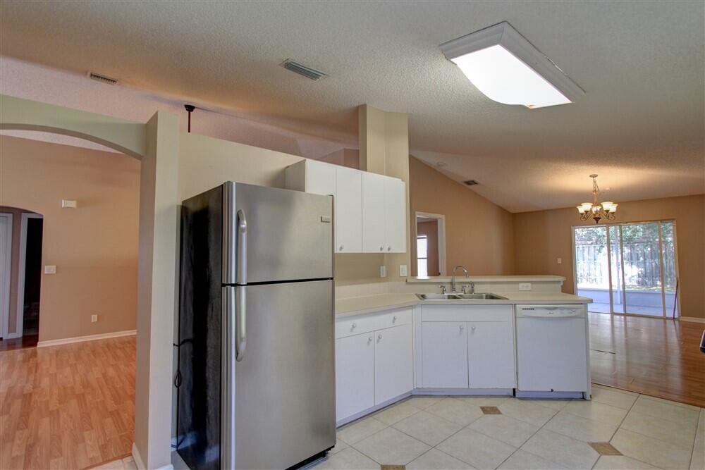 2477 Deercroft Drive Melbourne, FL 32940 - Photo 24 of 30 a kitchen with a refrigerator a sink and dishwasher