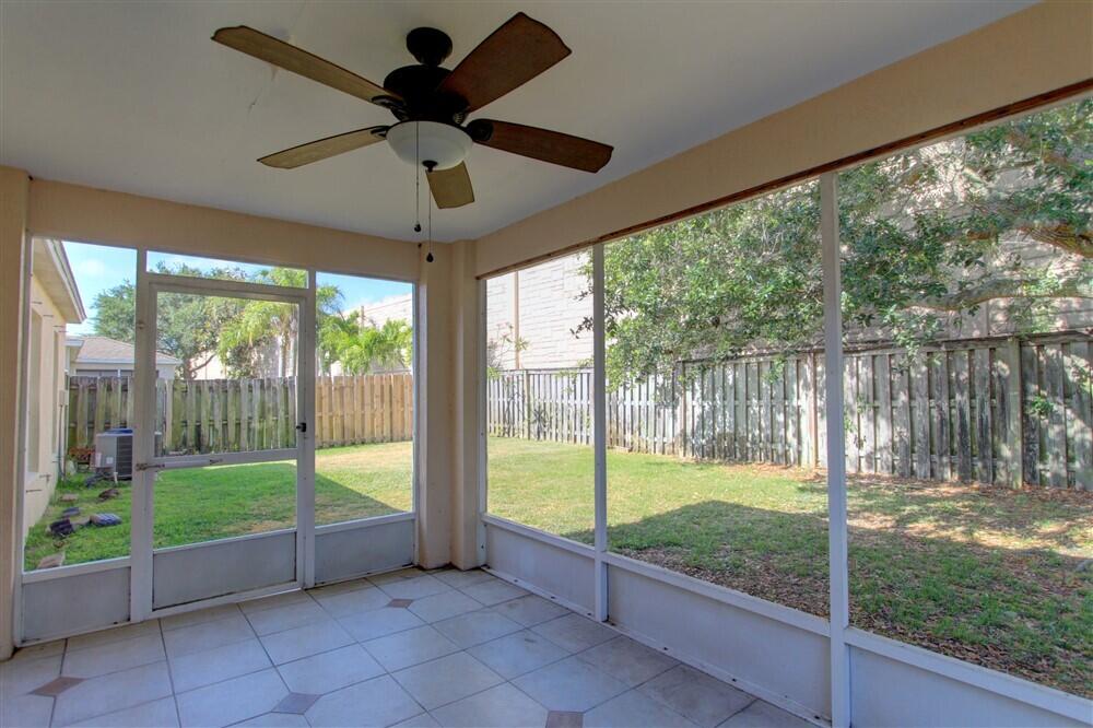 2477 Deercroft Drive Melbourne, FL 32940 - Photo 28 of 30 a living room with a floor to ceiling window and a yard