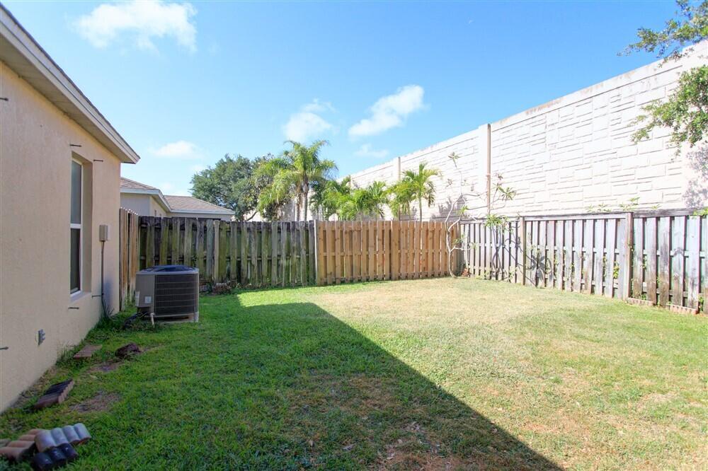 2477 Deercroft Drive Melbourne, FL 32940 - Photo 29 of 30 a backyard of a house with a garden and deck