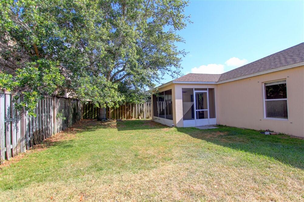 2477 Deercroft Drive Melbourne, FL 32940 - Photo 30 of 30 a view of a house with a yard and large tree