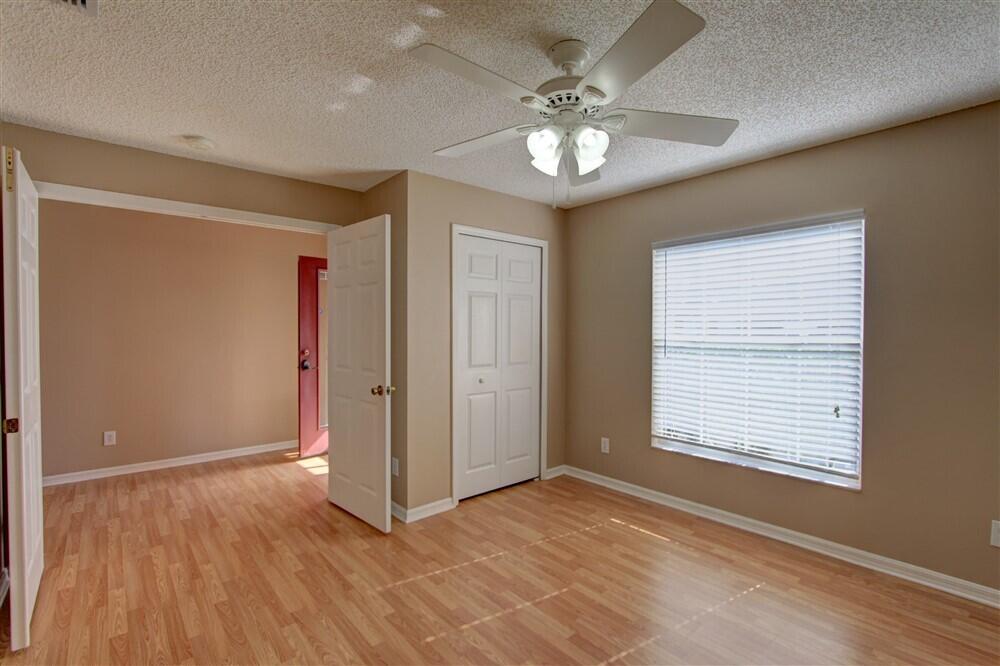 2477 Deercroft Drive Melbourne, FL 32940 - Photo 4 of 30 a view of an empty room with a window and wooden floor