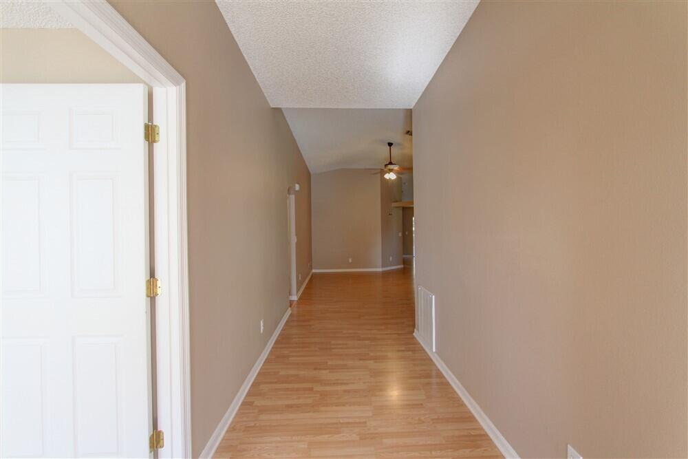 2477 Deercroft Drive Melbourne, FL 32940 - Photo 5 of 30 a view of a hallway with wooden floor