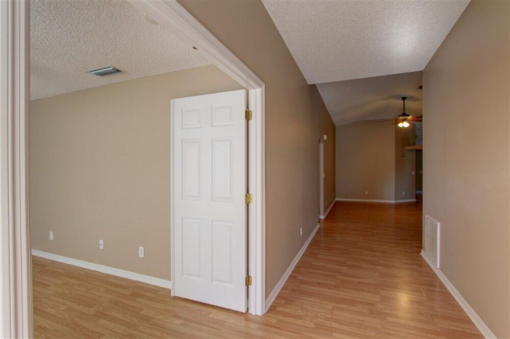 2477 Deercroft Drive Melbourne, FL 32940 - Photo 6 of 30 a view of a hallway with wooden floor