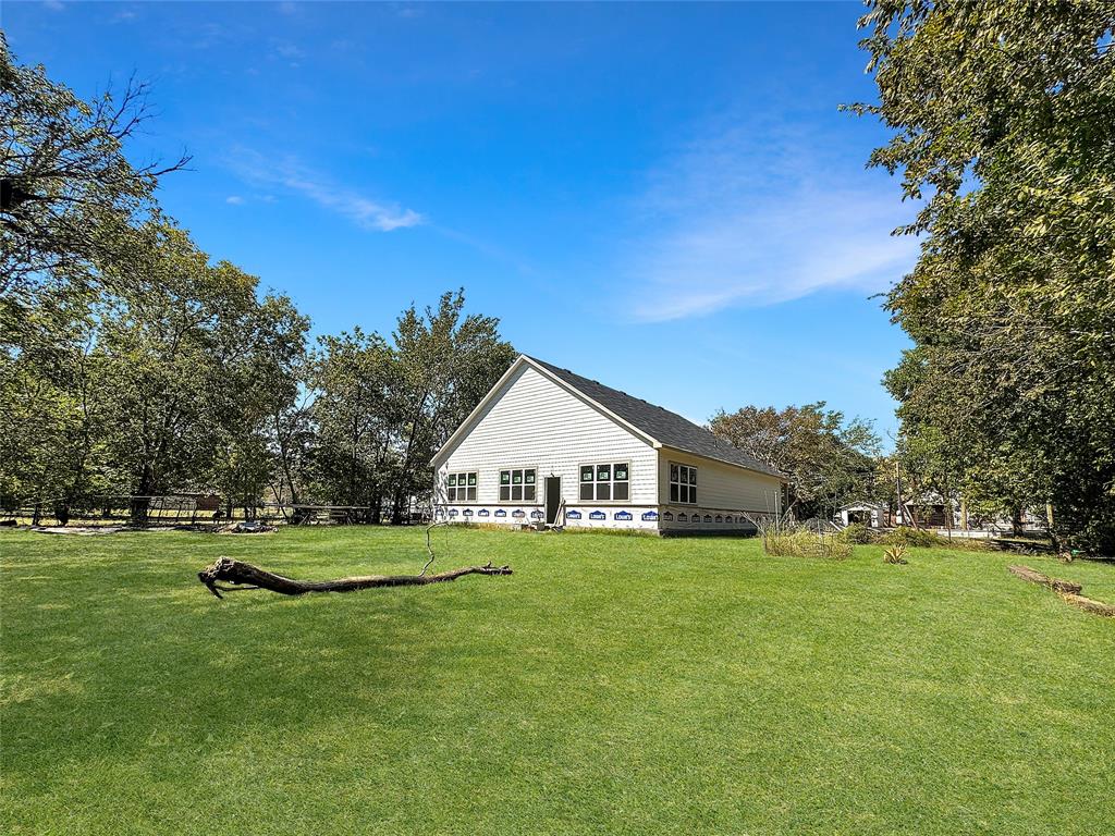 308 North McGraw Street Forney, TX 75126 - Photo 1 of 26 Back of property featuring a lawn