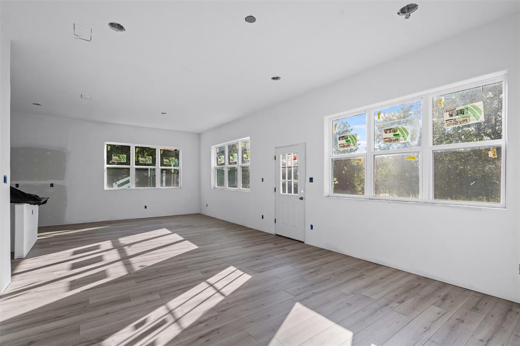 308 North McGraw Street Forney, TX 75126 - Photo 18 of 26 Unfurnished living room with wood finished floors and recessed lighting