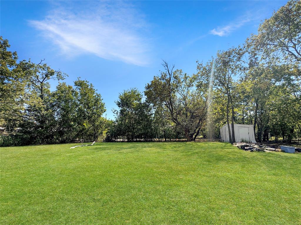 308 North McGraw Street Forney, TX 75126 - Photo 2 of 26 View of green lawn featuring a shed