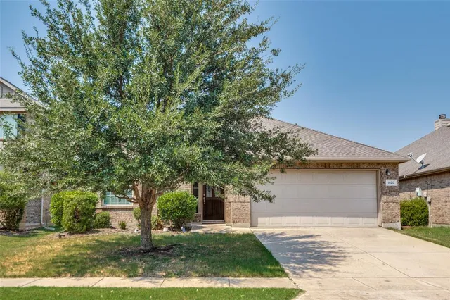 a view of a lake with houses in back