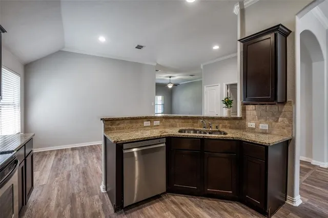 a kitchen with stainless steel appliances granite countertop a stove and a sink