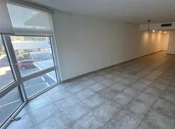 a view of an empty room and a window