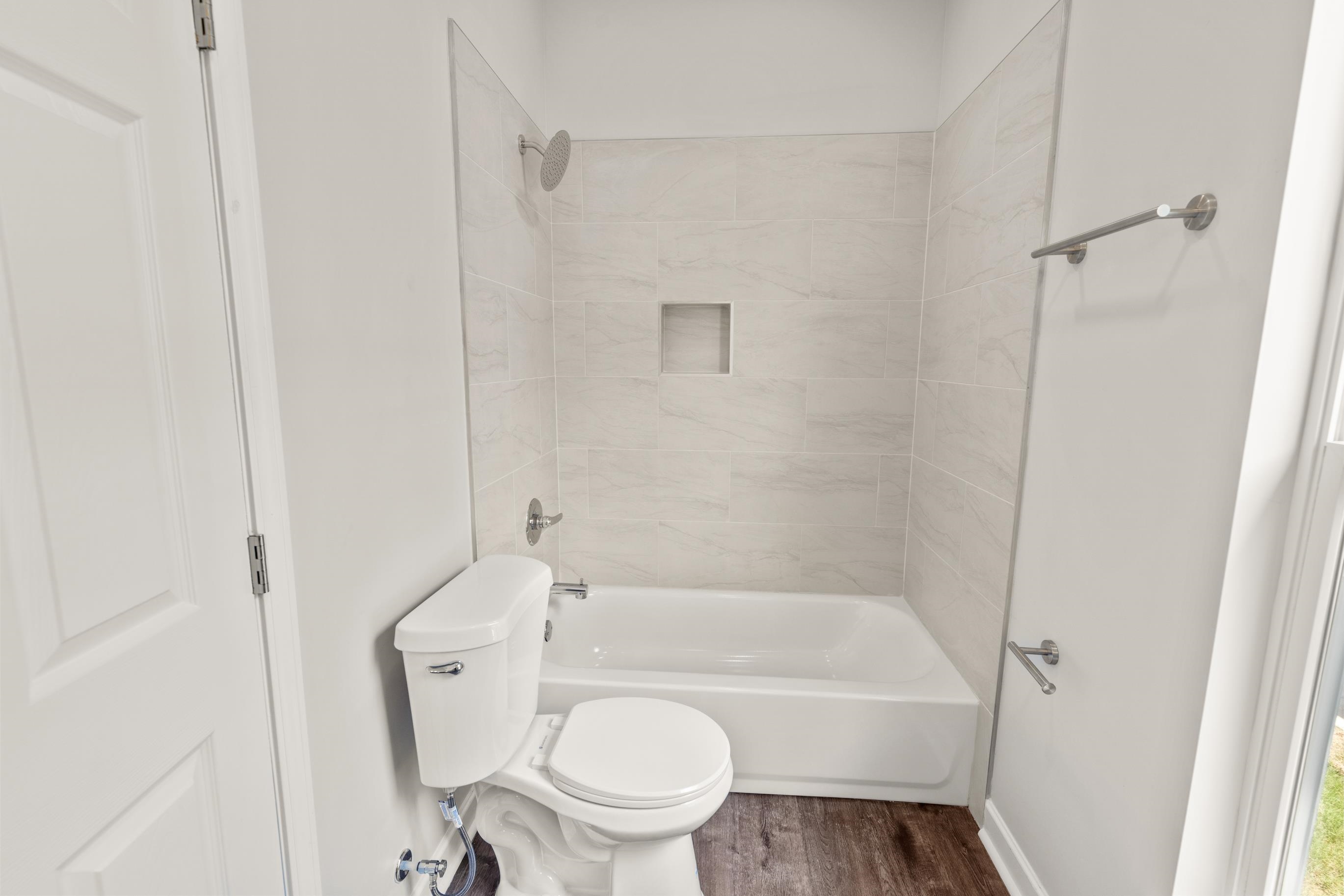 828 Semmes Street Memphis, TN 38111 - Photo 14 of 18 a white toilet sitting next to a bath tub