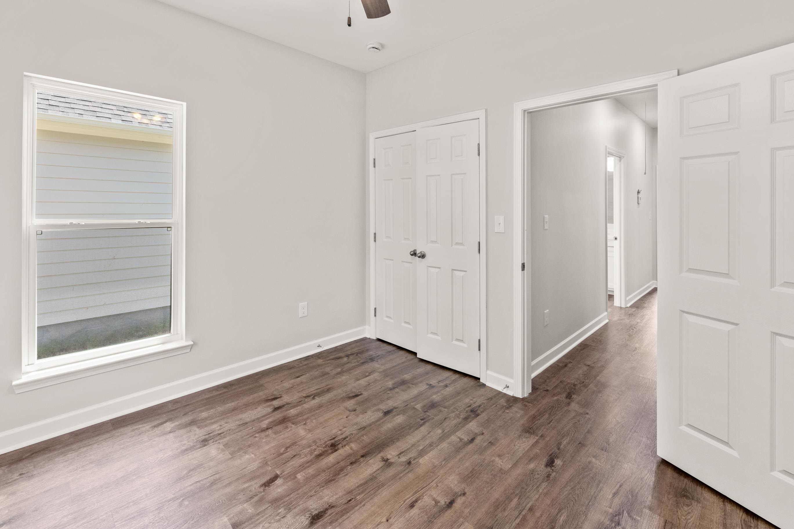 828 Semmes Street Memphis, TN 38111 - Photo 18 of 18 a view of an empty room with wooden floor and a window