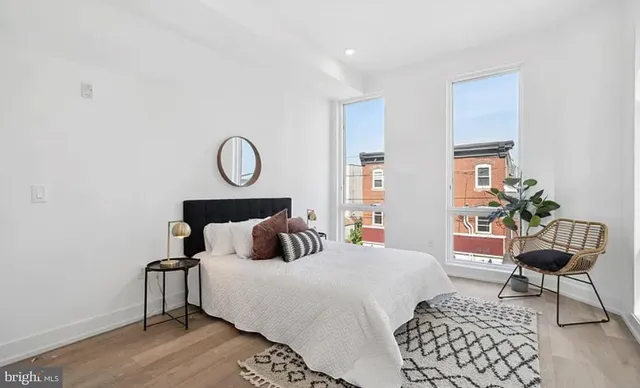 a bedroom with a bed and chair