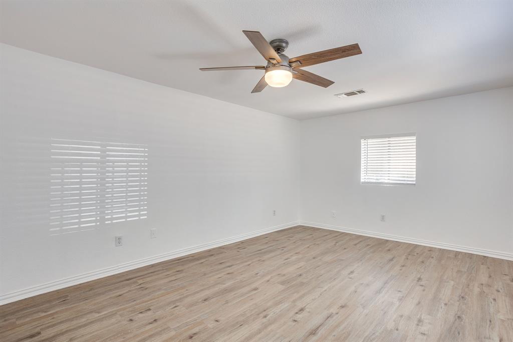 6940 Hatch Road Fort Worth, TX 76135 - Photo 22 of 40 Wood-finish flooring with white walls