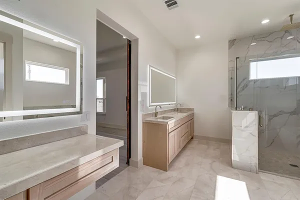 a bathroom with a tub sink and mirror