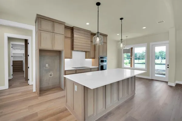 a large kitchen with stainless steel appliances kitchen island a large island in the center