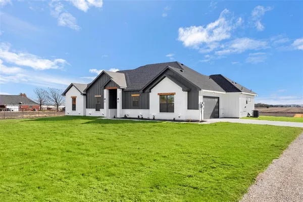 a front view of house with yard and green space