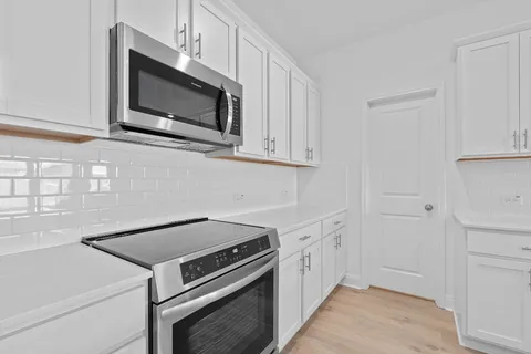 a kitchen with a stove microwave and sink