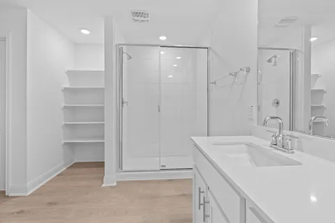 a bathroom with double vanity sink and a mirror