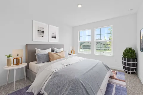 a bedroom with a large bed and a window