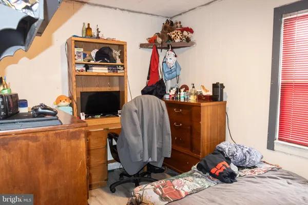 a living room with furniture a fireplace and a chandelier