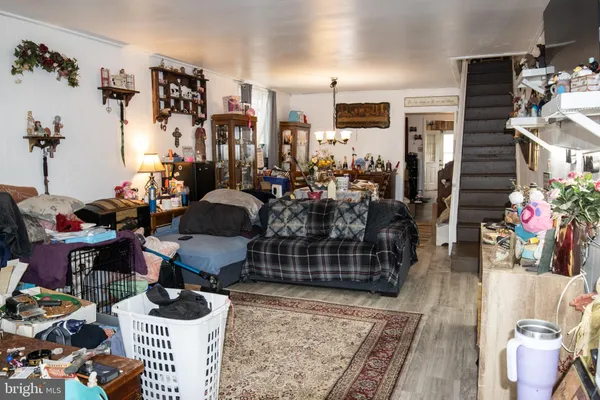 a room with lots of white furniture and a rug