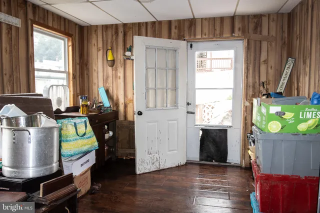 a room with wooden floor and windows
