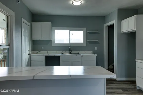 a kitchen with stainless steel appliances a sink stove and cabinets
